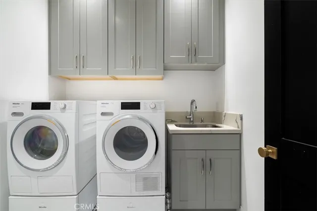 a utility room with sink dryer and washer