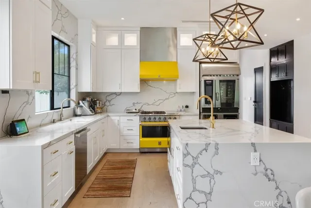 a kitchen with stainless steel appliances kitchen island granite countertop a sink and cabinets