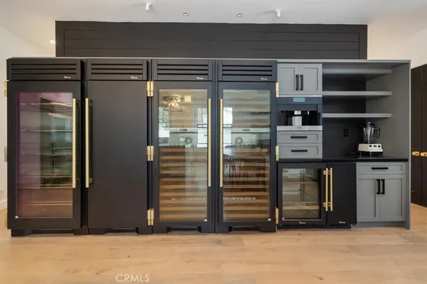a view of kitchen with refrigerator and cabinets