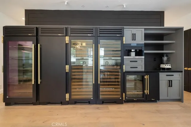 a view of kitchen with refrigerator and cabinets