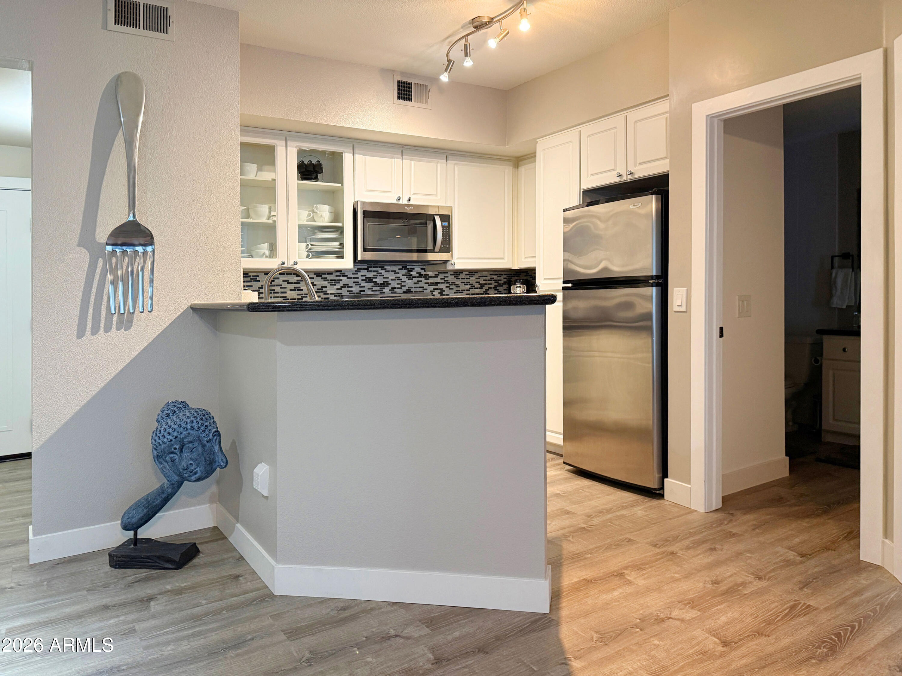 3633 North 3rd Avenue, Unit 1027 Phoenix, AZ 85013 - Photo 6 of 29 a view of kitchen with stainless steel appliances granite countertop a refrigerator and a sink
