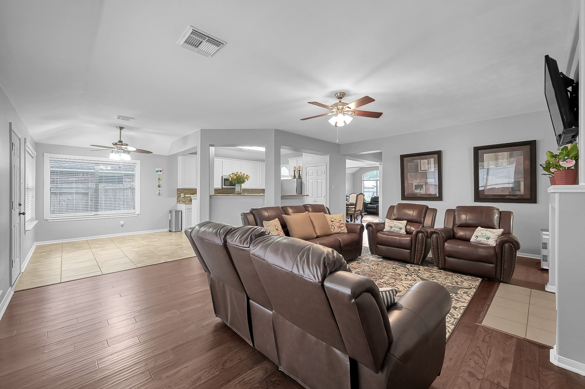 20251 Eden Pines Spring, TX 77379 - Photo 12 of 33 a living room with furniture a fireplace and a flat screen tv
