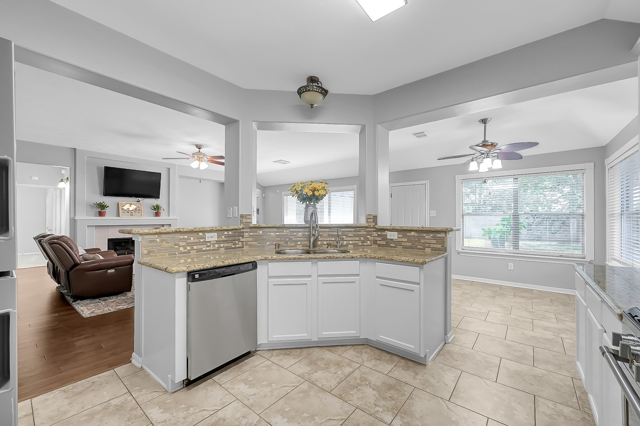 20251 Eden Pines Spring, TX 77379 - Photo 15 of 33 a kitchen with kitchen island granite countertop a stove and a sink