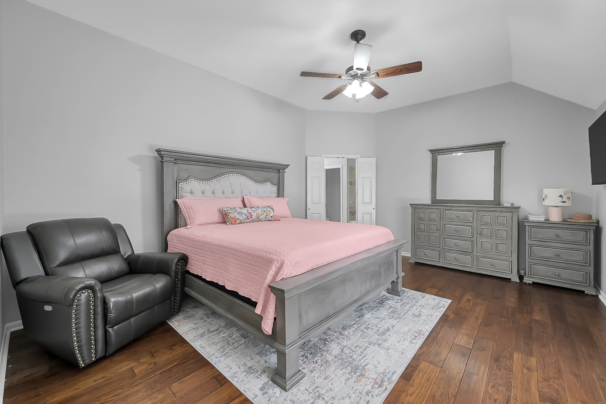 20251 Eden Pines Spring, TX 77379 - Photo 16 of 33 a spacious bedroom with a bed and wooden floor