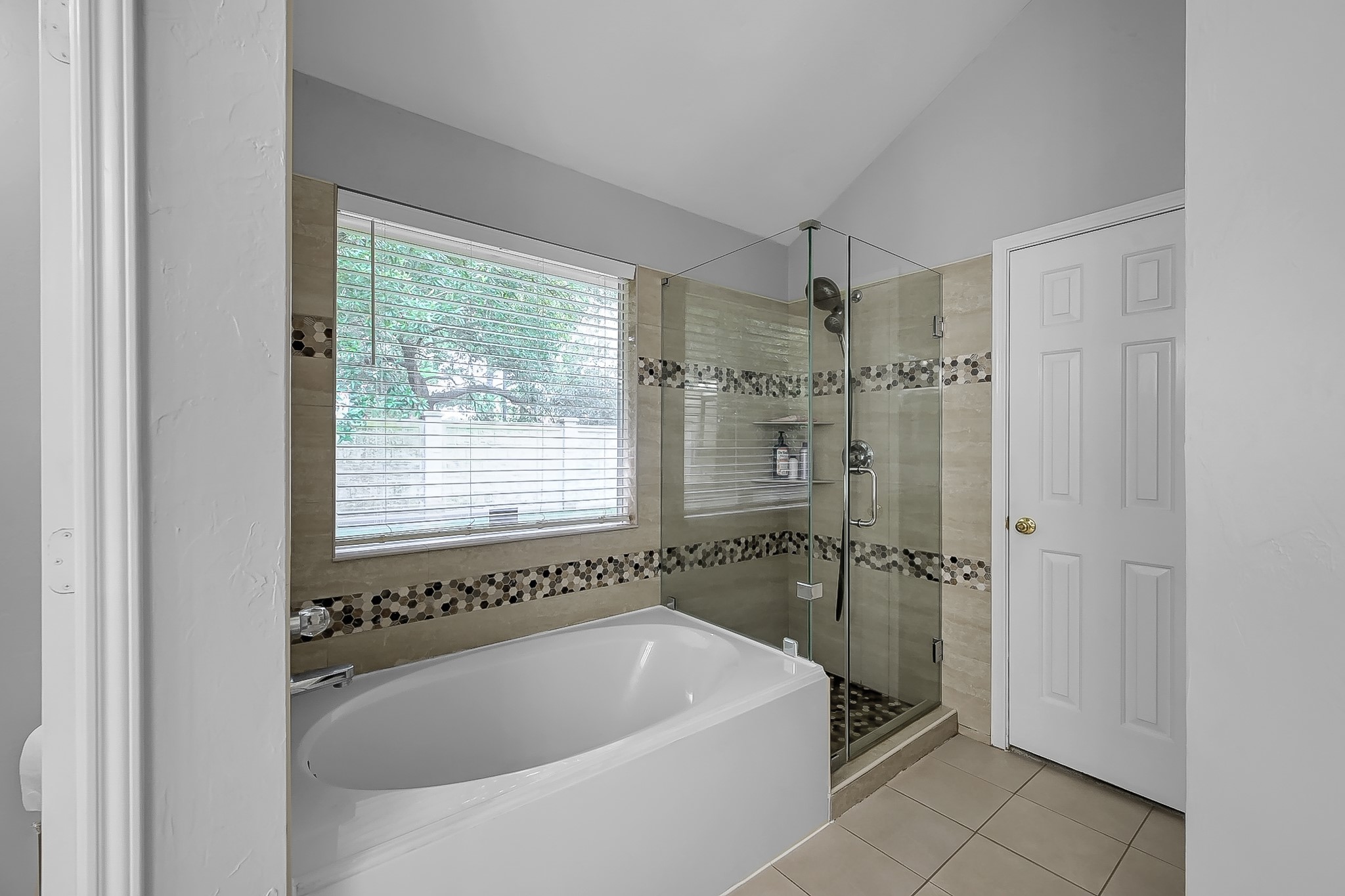 20251 Eden Pines Spring, TX 77379 - Photo 18 of 33 a bathroom with a bathtub and shower