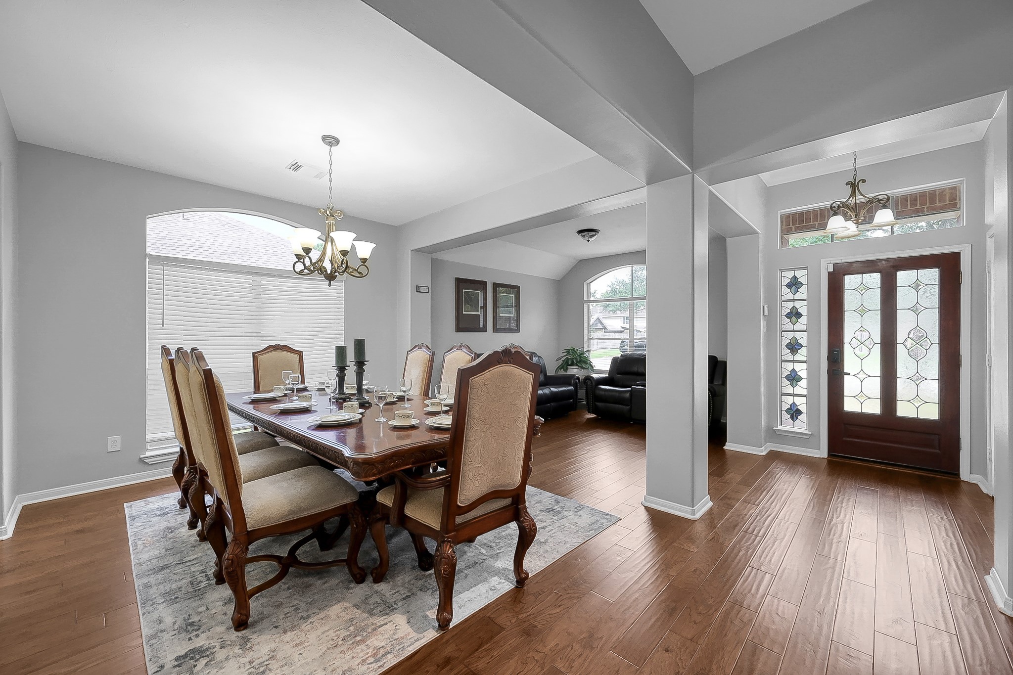 20251 Eden Pines Spring, TX 77379 - Photo 4 of 33 a dining room with furniture a chandelier and wooden floor