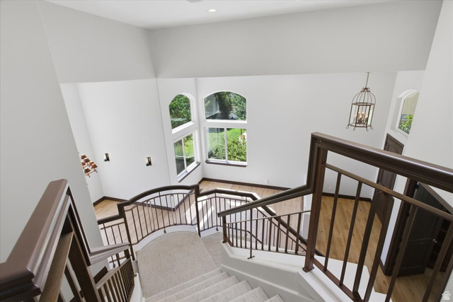 12317 Cypress Point Way Draper, UT 84020 - Photo 15 of 41 Multi-level staircase featuring neutral carpeted treads and dark wood-finish railings with wrought iron spindles