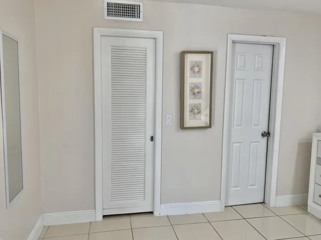a view of an entryway with cabinet