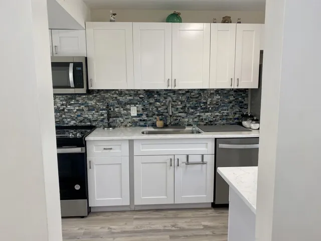 a kitchen with a sink and cabinets