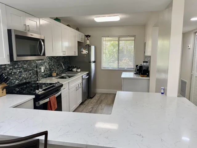 a kitchen with a stove a sink and a microwave