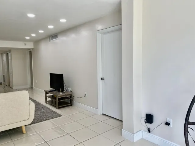 a view of kitchen with furniture and flat screen tv