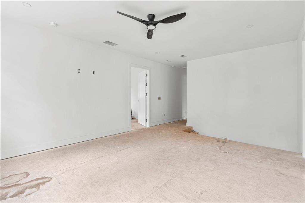 2659 Flat Shoals Road Decatur, GA 30034 - Photo 11 of 20 an empty room with a ceiling fan and wooden floor