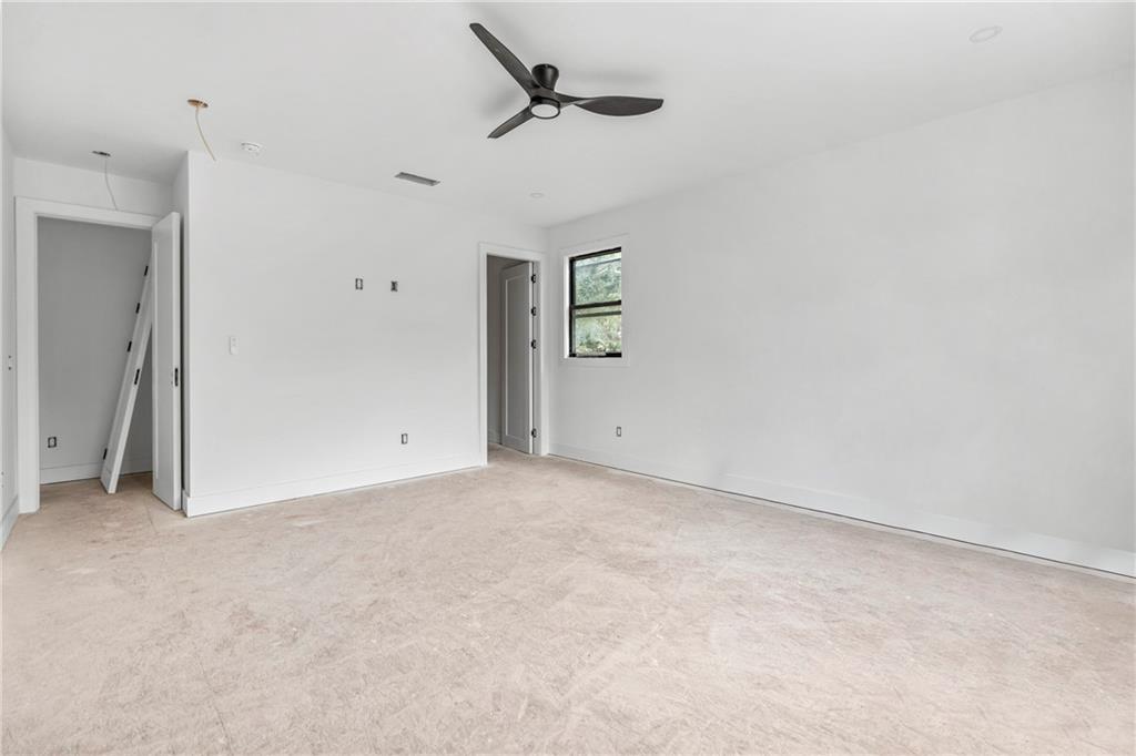 2659 Flat Shoals Road Decatur, GA 30034 - Photo 12 of 20 an empty room with a ceiling fan and a window