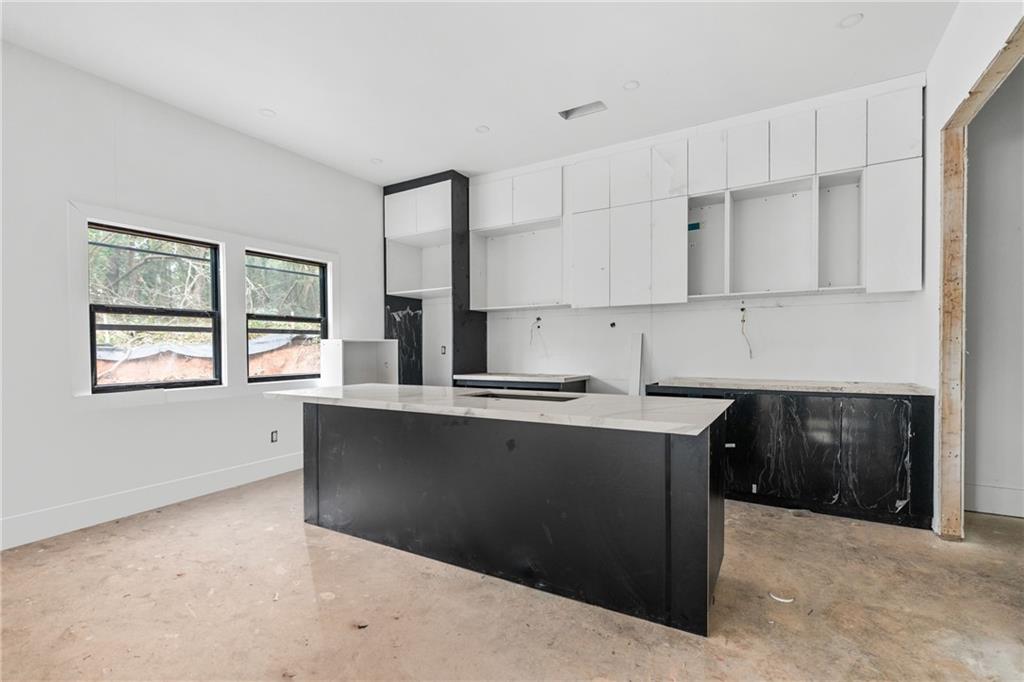 2659 Flat Shoals Road Decatur, GA 30034 - Photo 6 of 20 a kitchen with stainless steel appliances granite countertop a stove a sink and a microwave