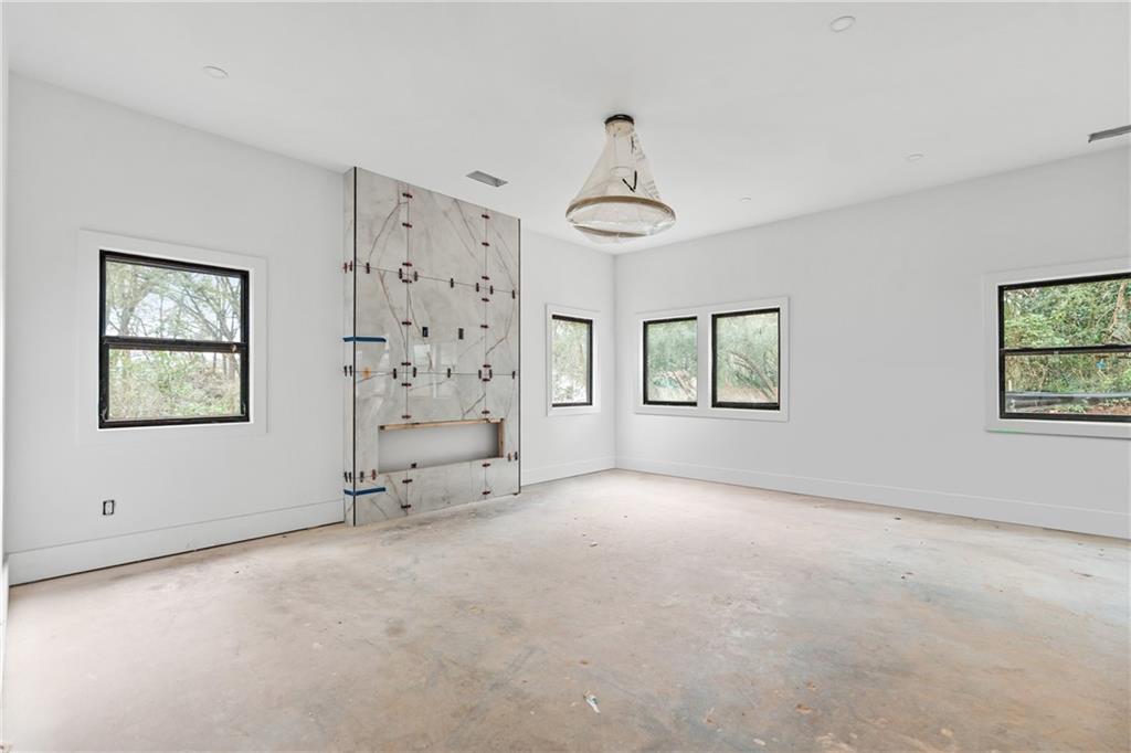 2659 Flat Shoals Road Decatur, GA 30034 - Photo 7 of 20 an empty room with windows and chandelier fan