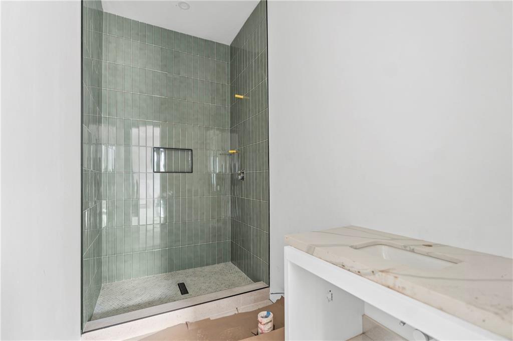 2659 Flat Shoals Road Decatur, GA 30034 - Photo 9 of 20 a bathroom with a granite countertop sink a mirror and shower