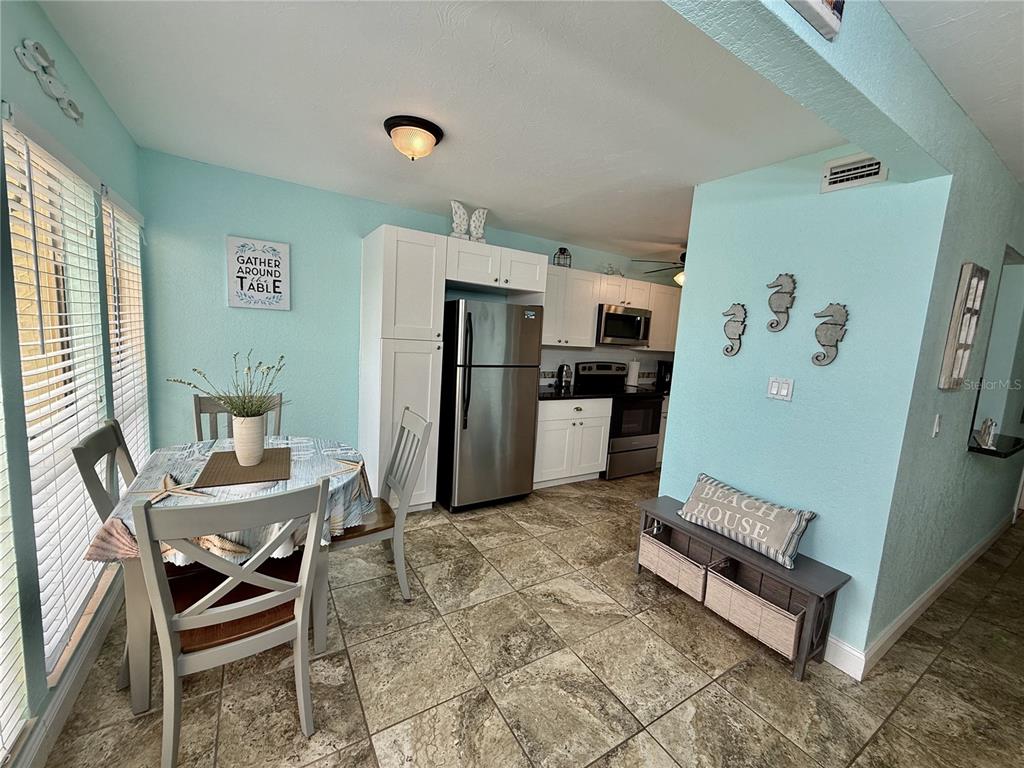 3405 Clark Road, Unit 106 Sarasota, FL 34231 - Photo 3 of 19 a living room with furniture and a refrigerator