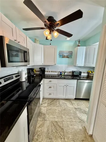 a kitchen with stainless steel appliances granite countertop a stove cabinets and a refrigerator