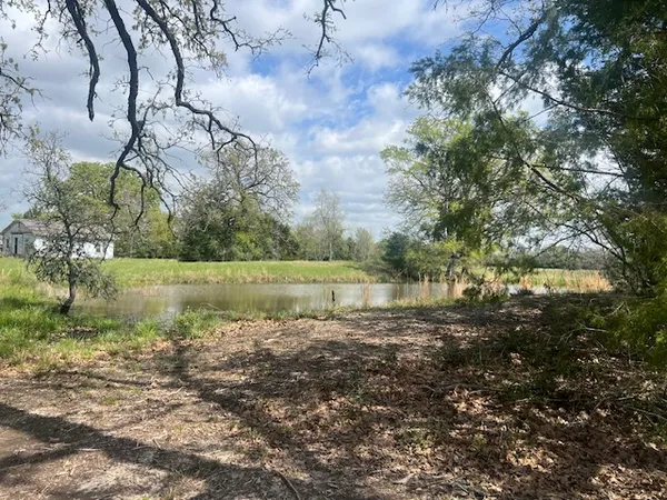 a view of a lake with a yard