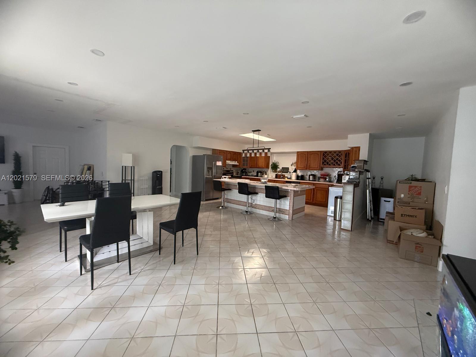 22445 Southwest 264th Street Homestead, FL 33031 - Photo 3 of 12 a living room with lots of furniture and a view of kitchen