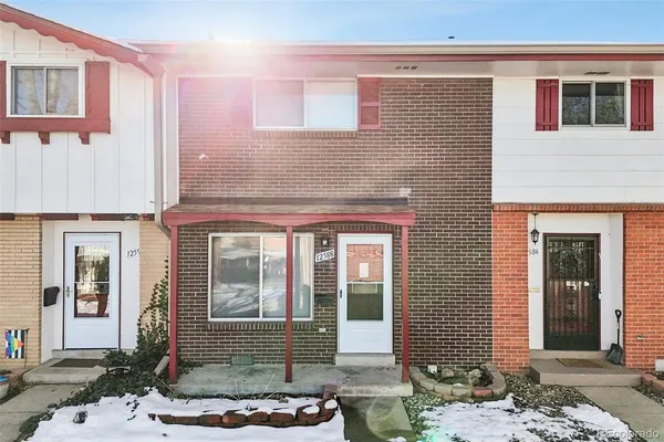 a front view of a house with a floor to ceiling windows and wooden floor