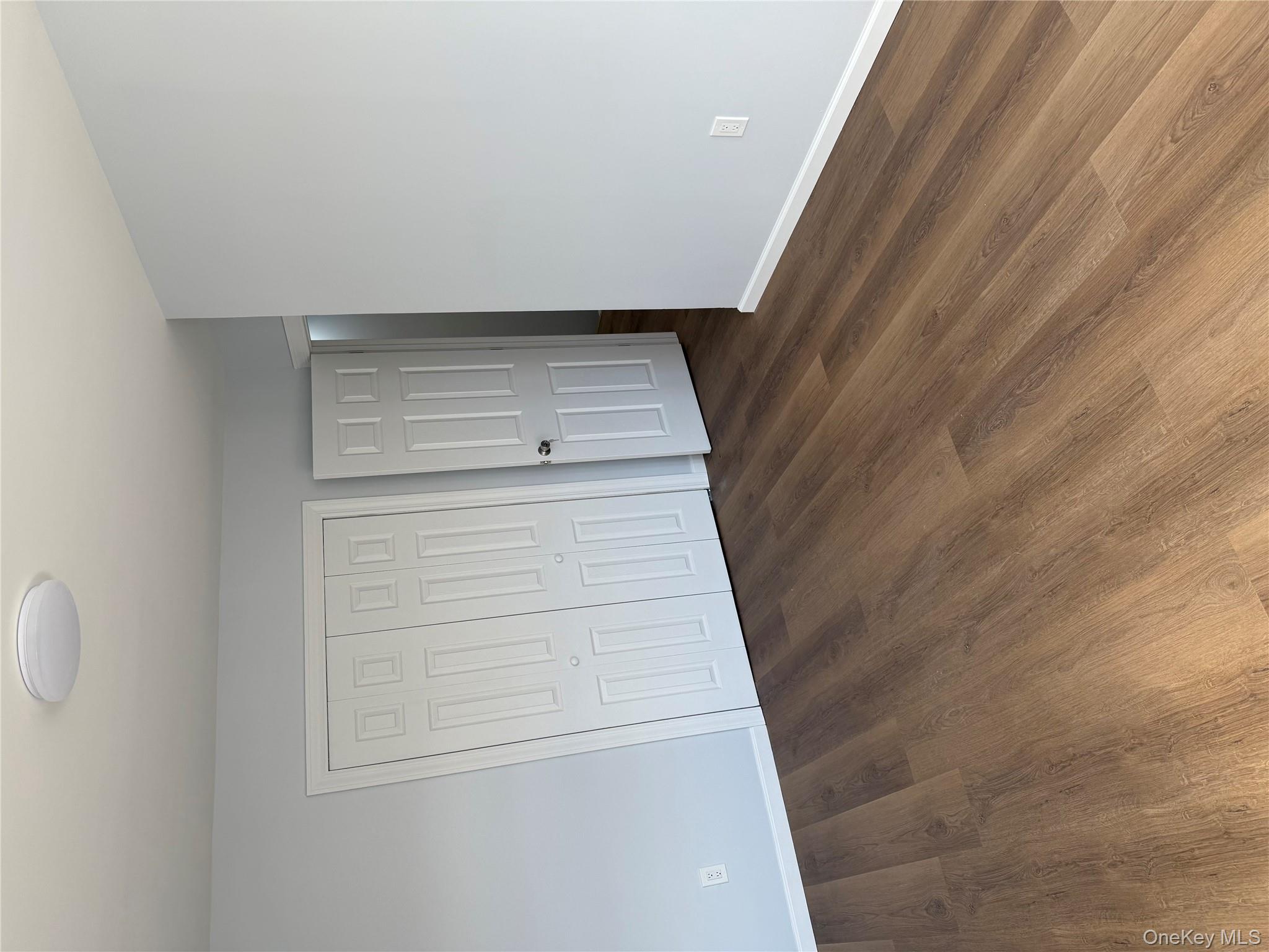 107-31 121st Street Queens, NY 11419 - Photo 8 of 20 a view of an empty room with wooden floor