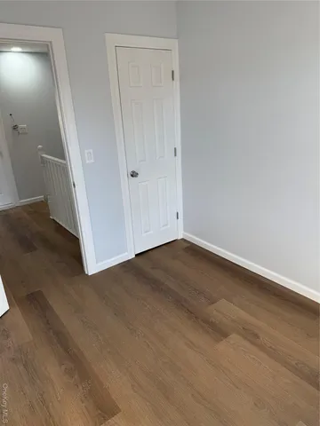 an empty room with wooden floor