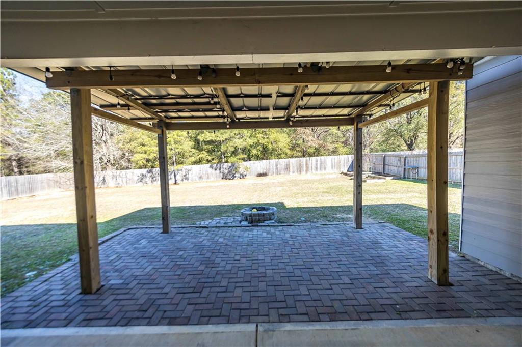 70 Apache Trail Fort Mitchell, AL 36856 - Photo 28 of 33 Fenced backyard featuring a patio area and a fire pit