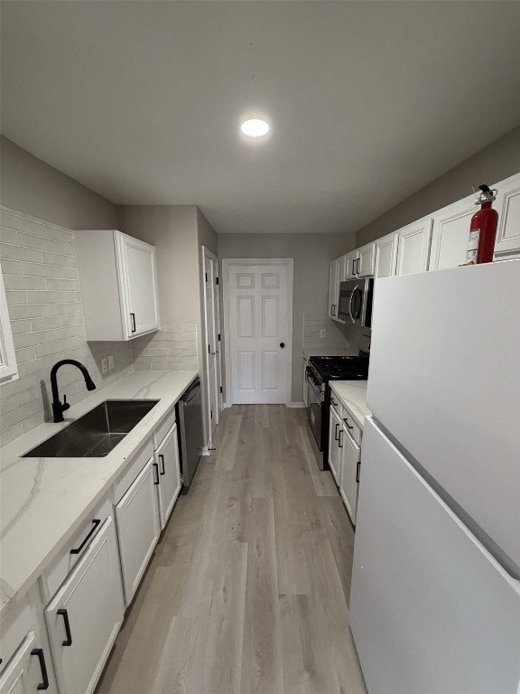 2006 Kilgore Road, Unit 101 Baytown, TX 77520 - Photo 4 of 9 a kitchen with granite countertop a sink and refrigerator