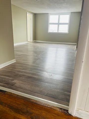 a view of wooden floor and cabinet in a room