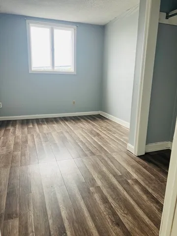 a view of an empty room and wooden floor