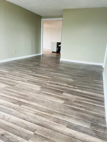 a view of a room with wooden floor