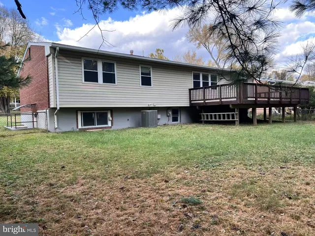 a view of a house with yard and a porch