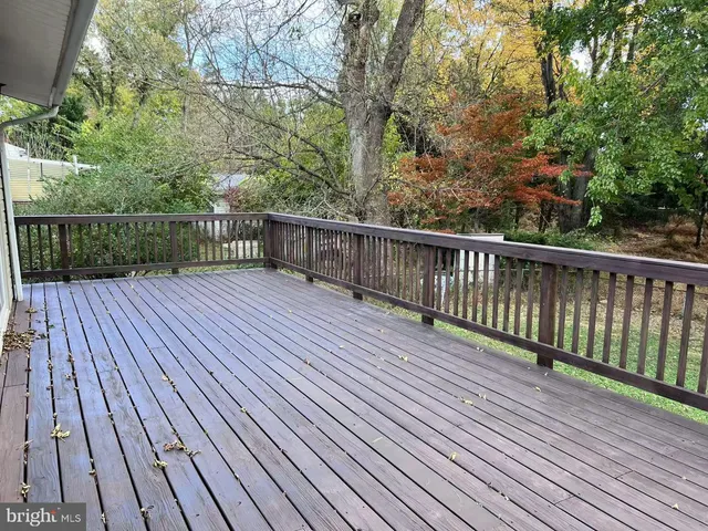 a view of deck with wooden floor and fence