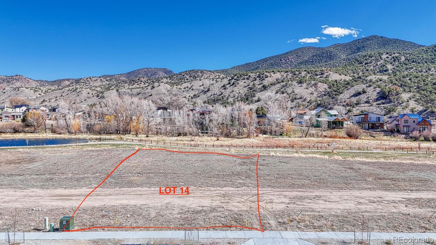 236 Southside Loop Salida, CO 81201 - Photo 1 of 13 a view of a dry yard with mountain and tree in the background