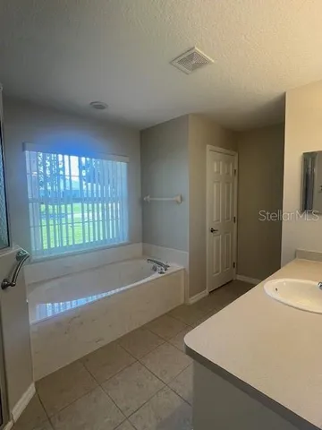 a spacious bathroom with a bathtub and a shower