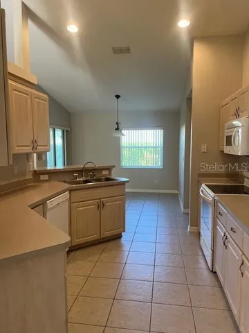 a kitchen with stainless steel appliances granite countertop a sink and a stove