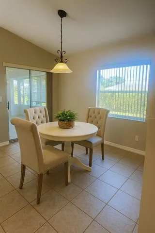 a dining room with furniture and window