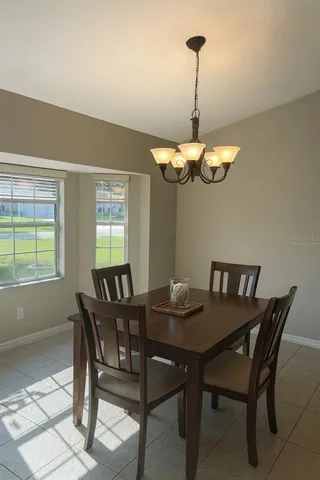a view of a dining room with a table and chairs