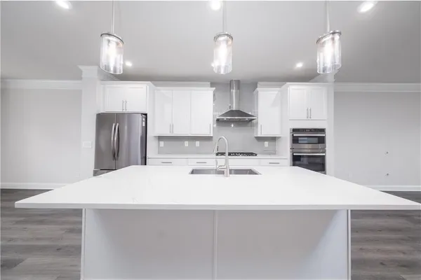 a large kitchen with kitchen island a sink stainless steel appliances and cabinets