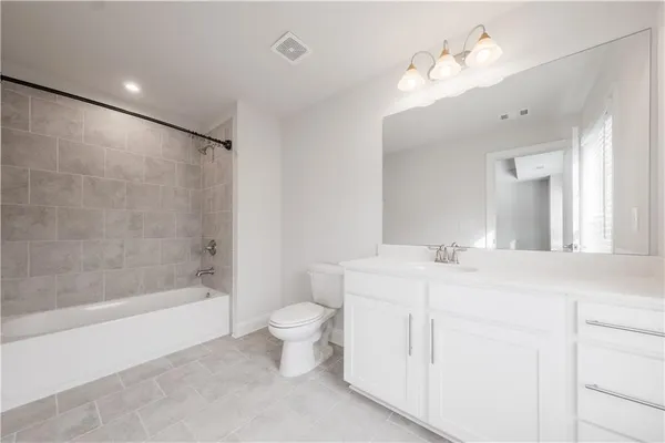 a bathroom with a toilet a sink and a bathtub