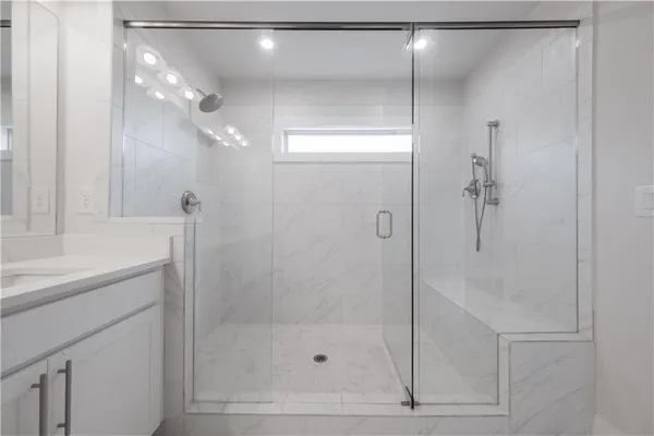 a bathroom with a shower and a sink