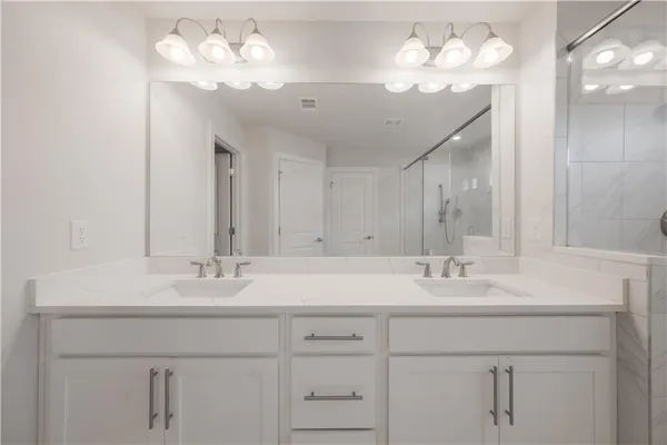 a bathroom with a sink vanity and a mirror