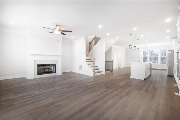 a view of a room with wooden floor and a fireplace
