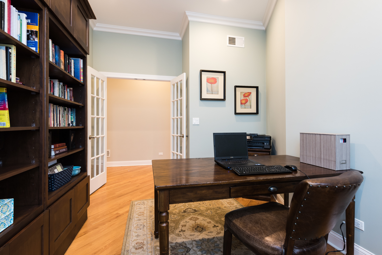 1330 Kenton Road Deerfield, IL 60015 - Photo 8 of 24 a view of a workspace with furniture and a book shelf