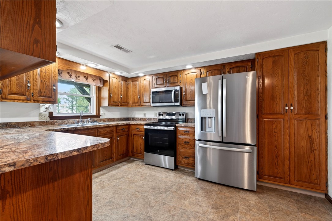 7988 McCool Road Greenville, OH 45331 - Photo 7 of 50 This spacious kitchen offers ample cabinetry, modern appliances, and bright task lighting for effortless meal preparation.