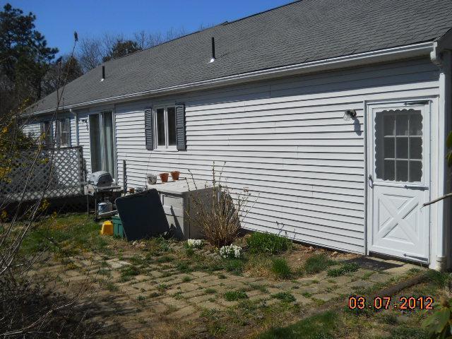 38 Captain Jacs Road Centerville, MA 02632 - Photo 8 of 8 a backyard of a house with yard and outdoor seating