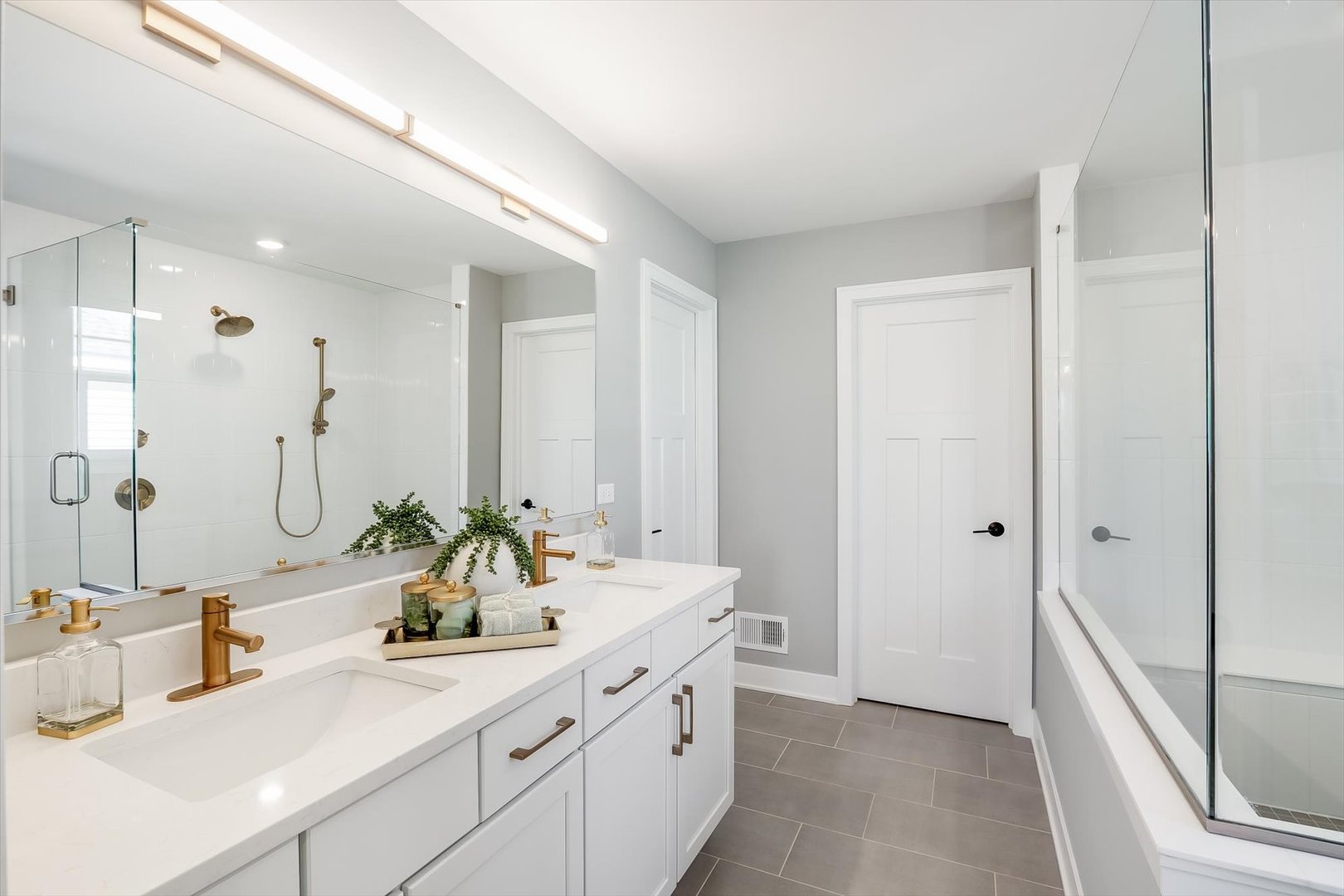 171 Piper Glen Avenue Oswego, IL 60543 - Photo 25 of 31 a bathroom with a double vanity sink mirror double and shower