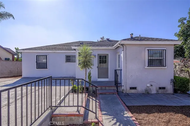 a view of a house with a wooden fence
