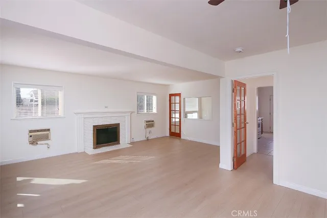 a view of empty room with a fireplace and window